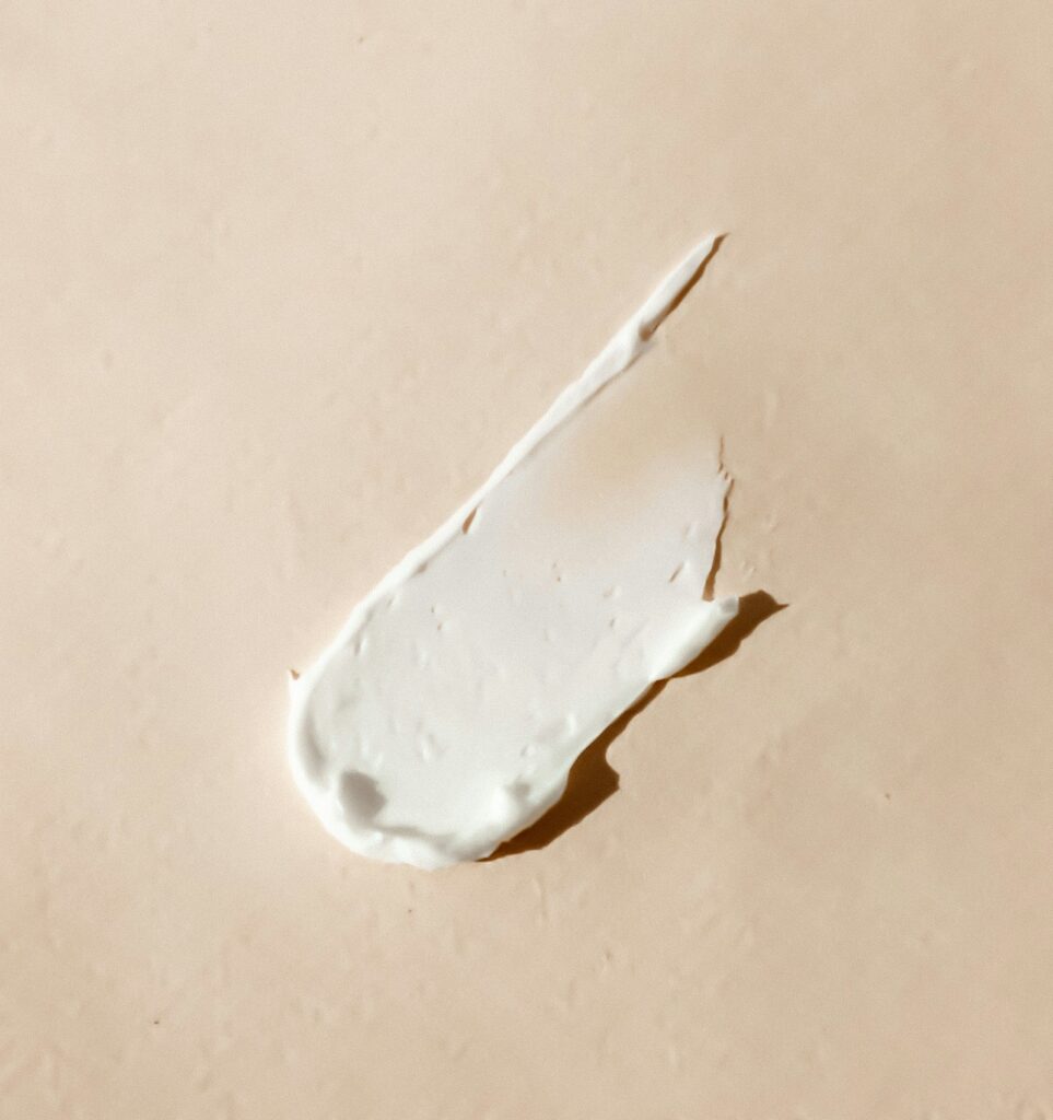 A swatch of rich white cream on a warm beige surface